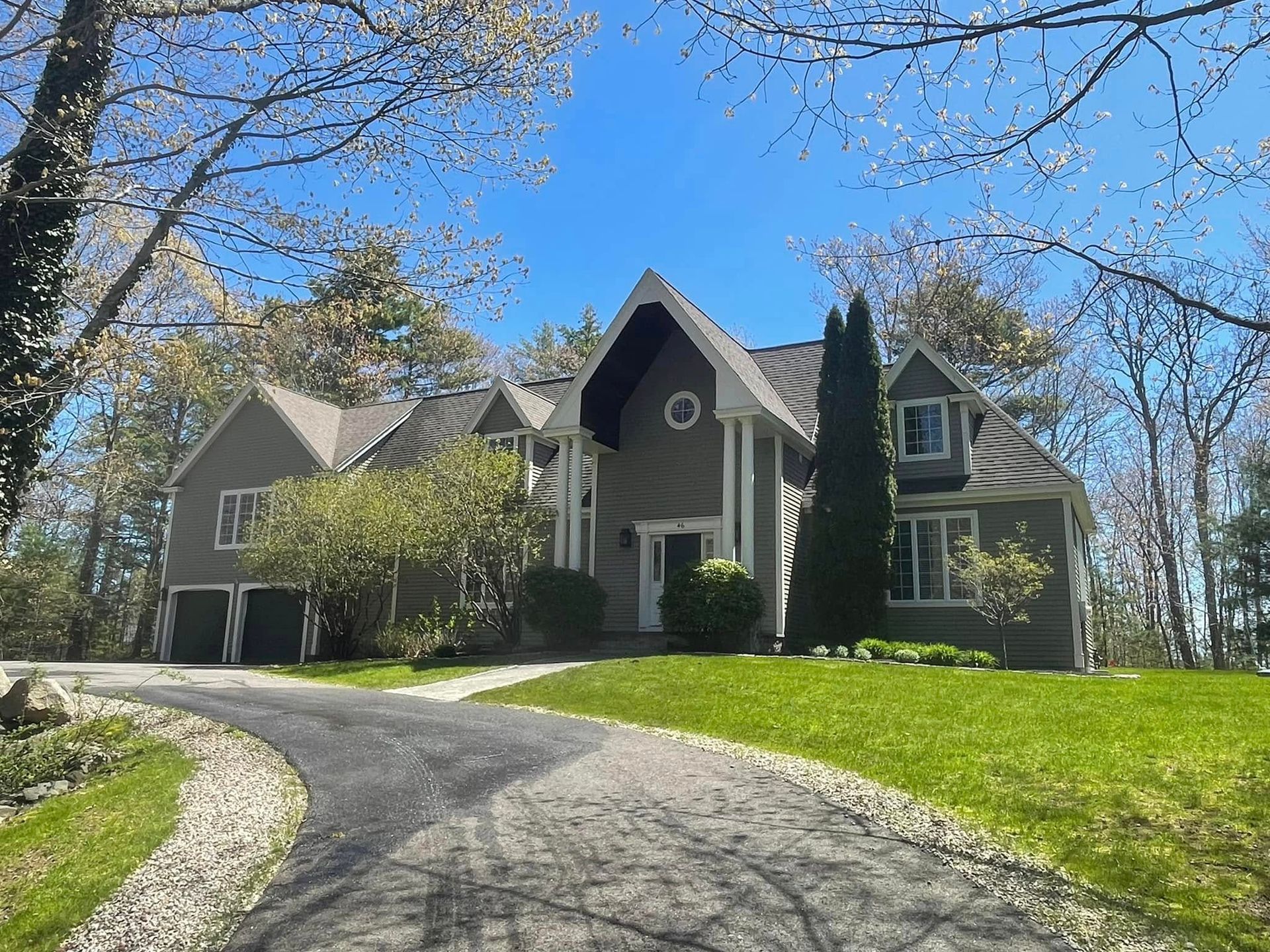 A large house with a driveway leading to it