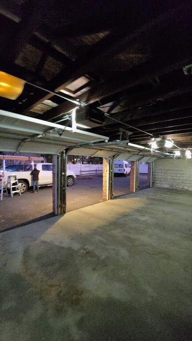 A garage with a lot of cars parked in it.