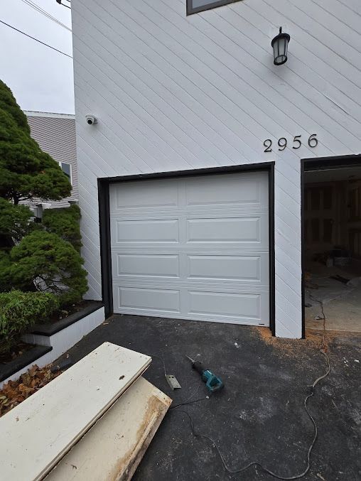 A white garage door with the number 2956 on it
