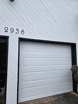 A white garage door with the number 2956 on it.