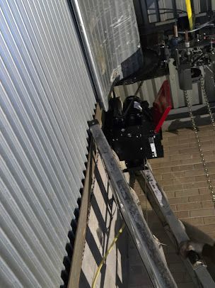 A ladder is hanging from the side of a building.