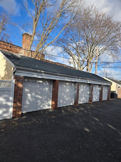 A row of garage doors on the side of a house.