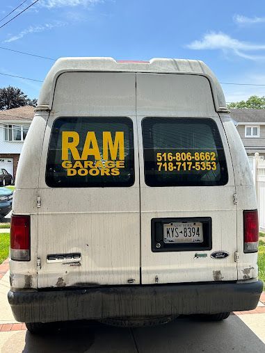 A white van with ram garage doors written on the back window