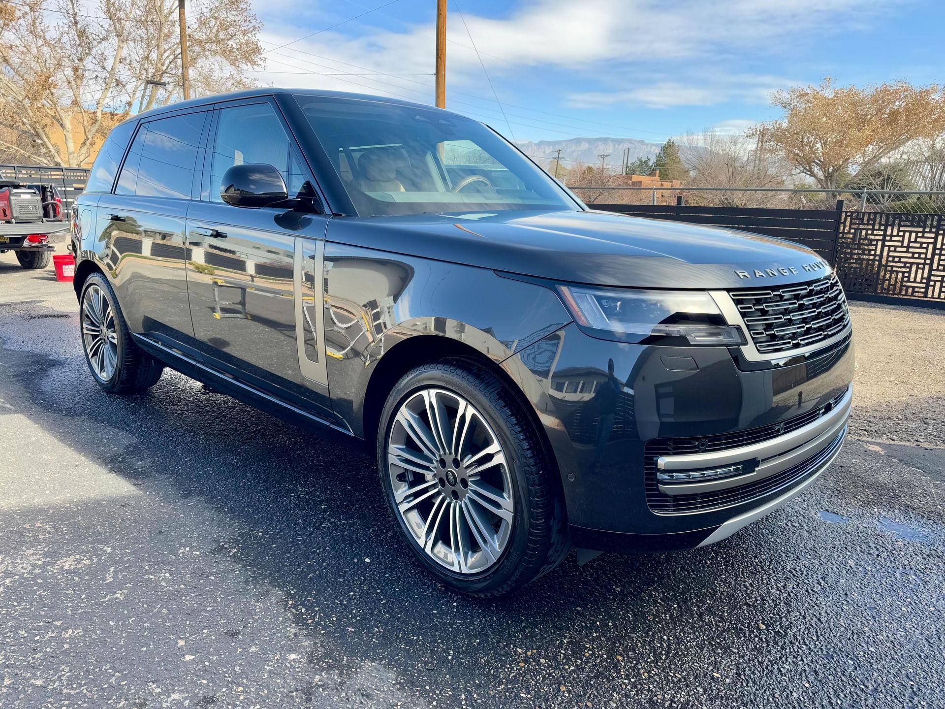 Dark blue Range Rover SUV parked outside on a sunny day.
