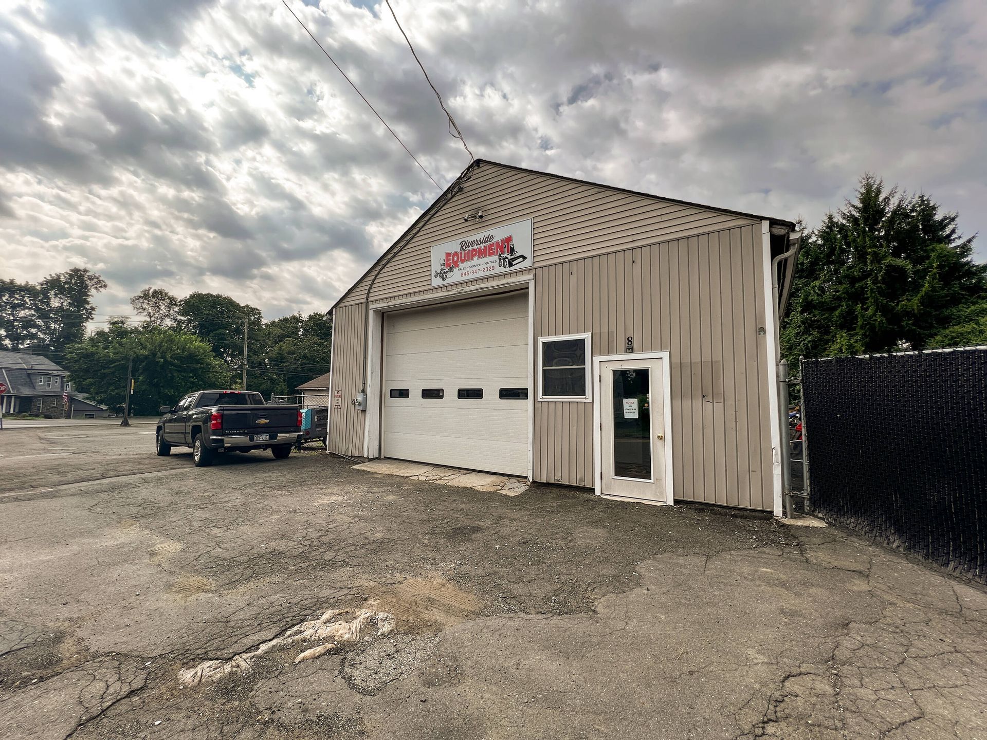 A truck is parked in front of a garage.