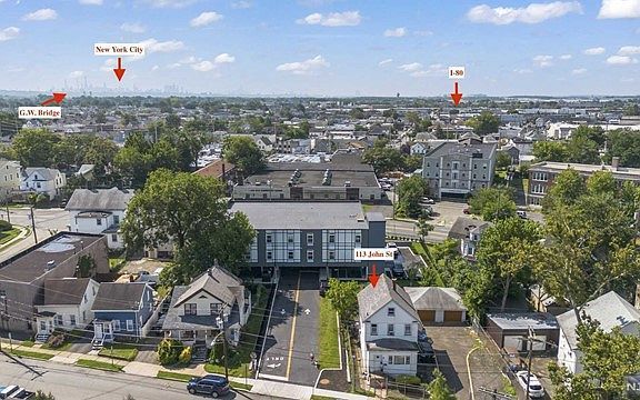 An aerial view of a city with a lot of houses and trees.