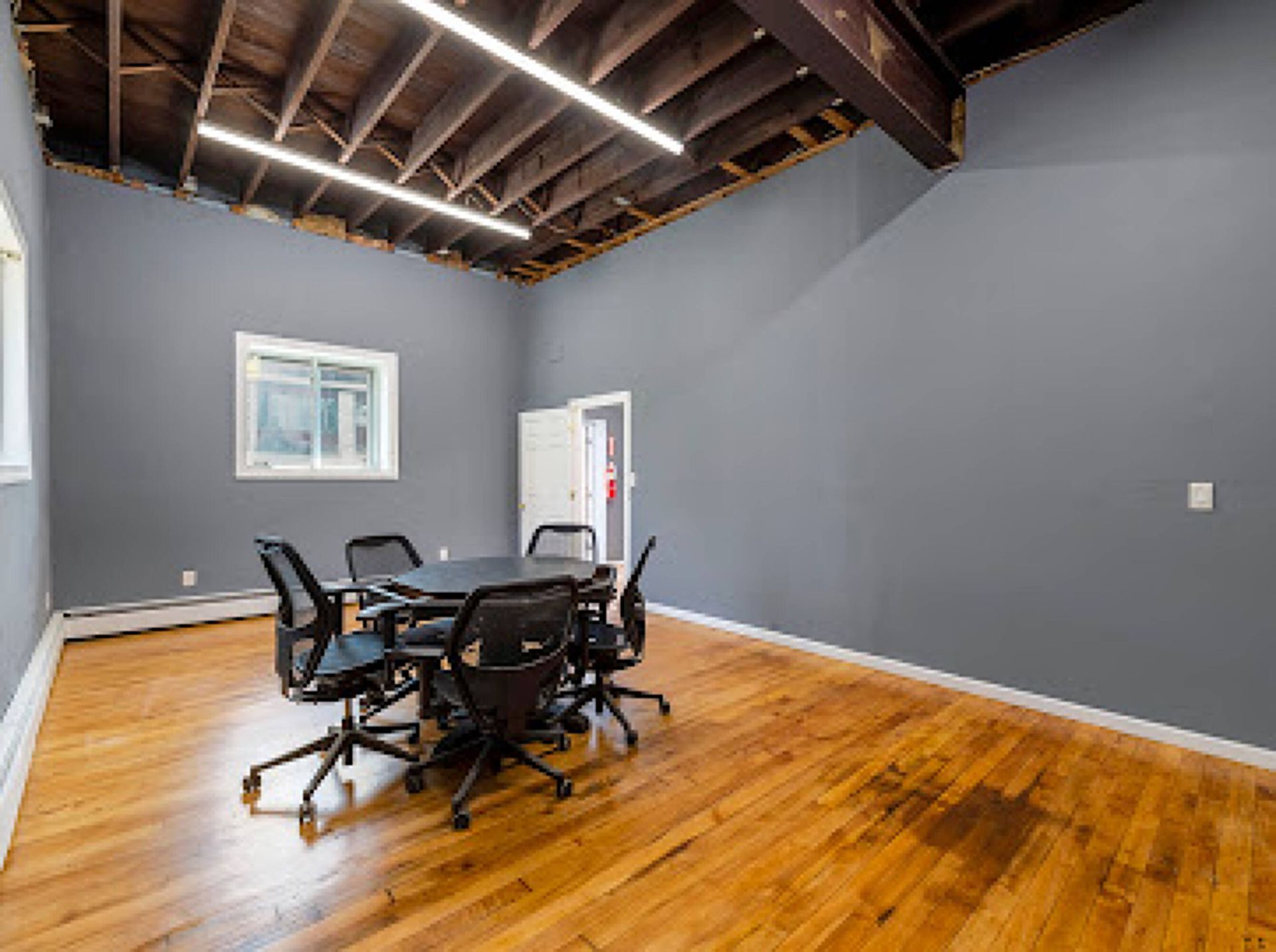 A conference room with a table and chairs in it.