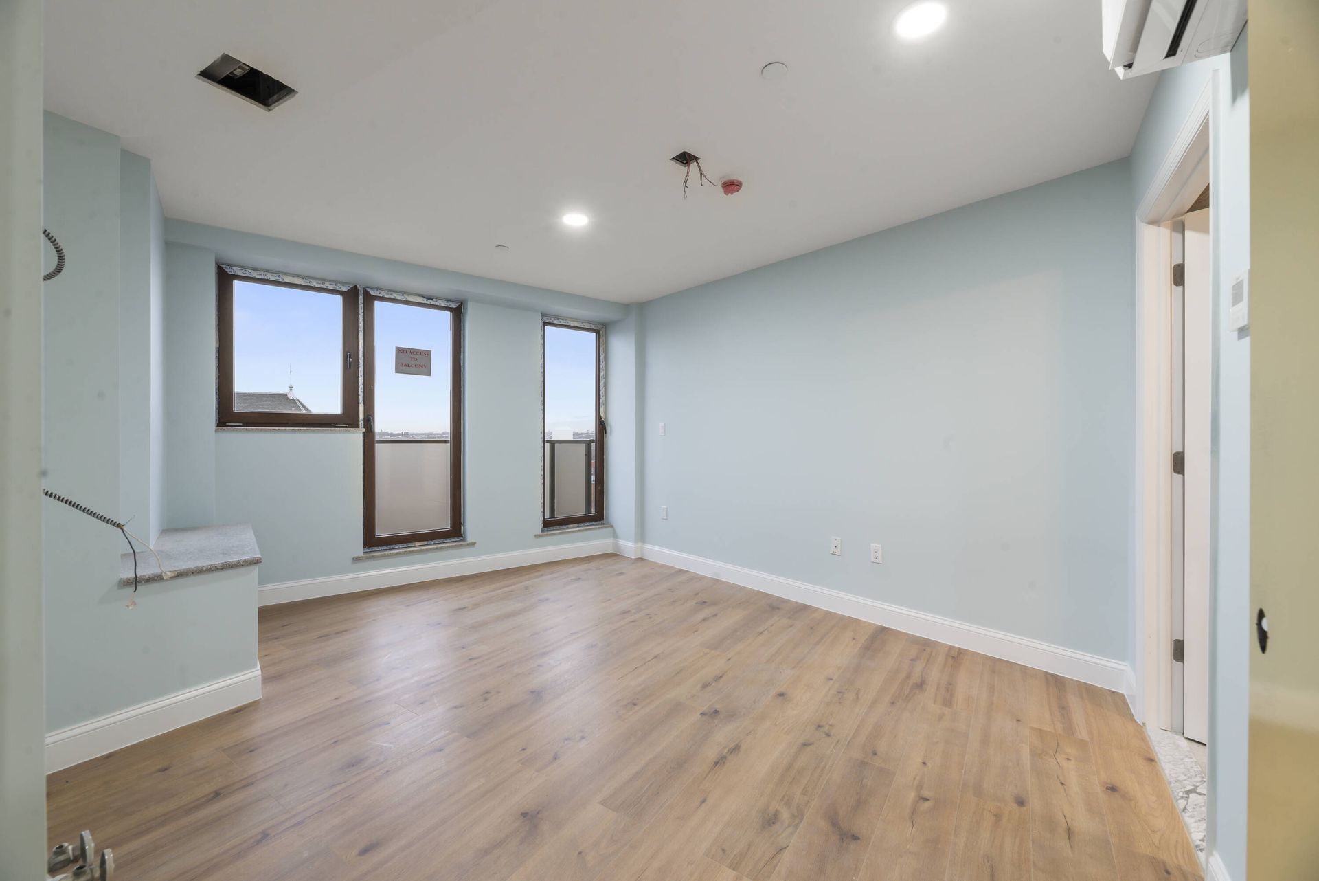 An empty room with hardwood floors and blue walls