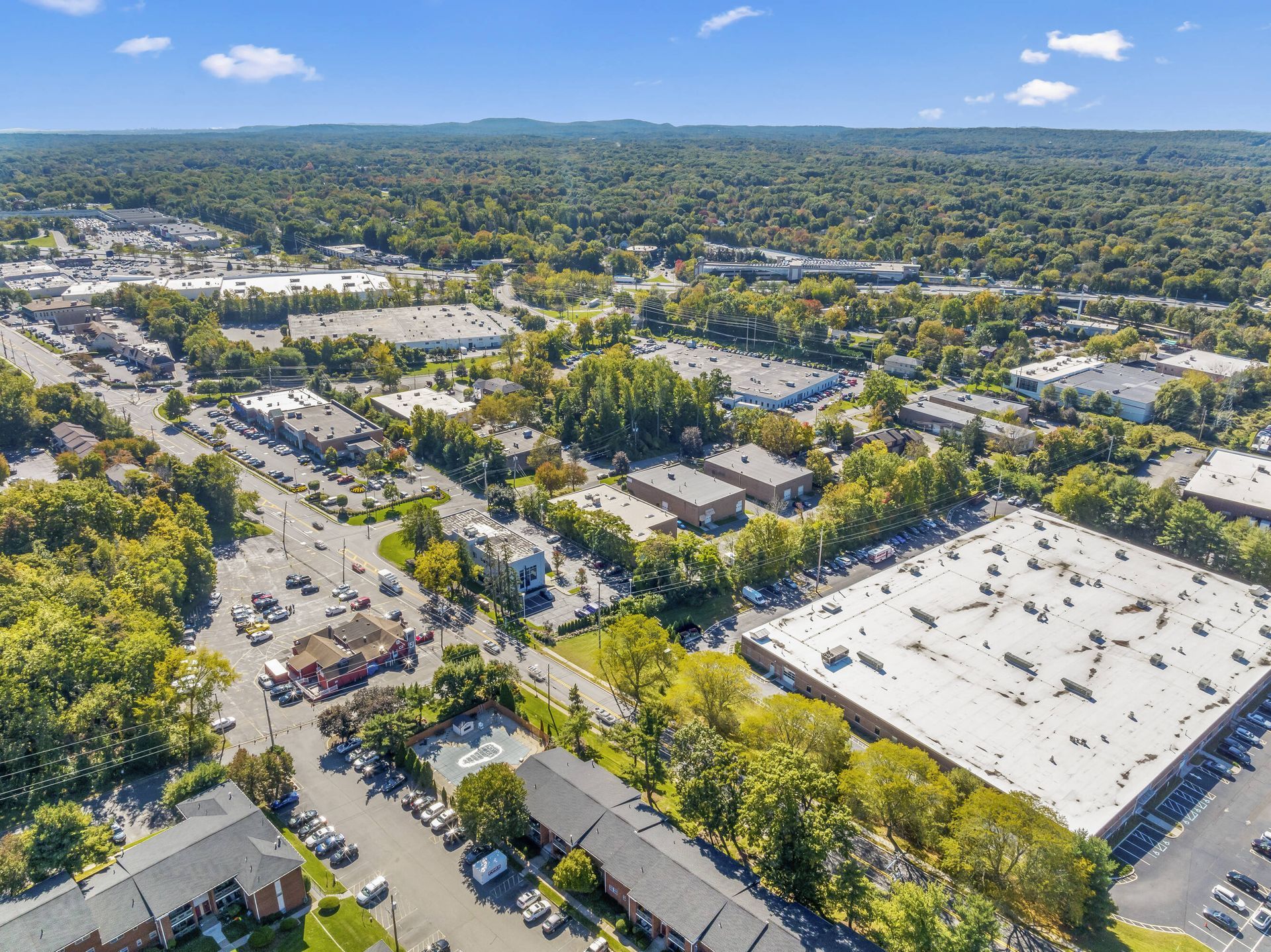 An aerial view of a city with lots of buildings and trees.