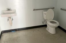 There is a toilet and a sink in the bathroom.