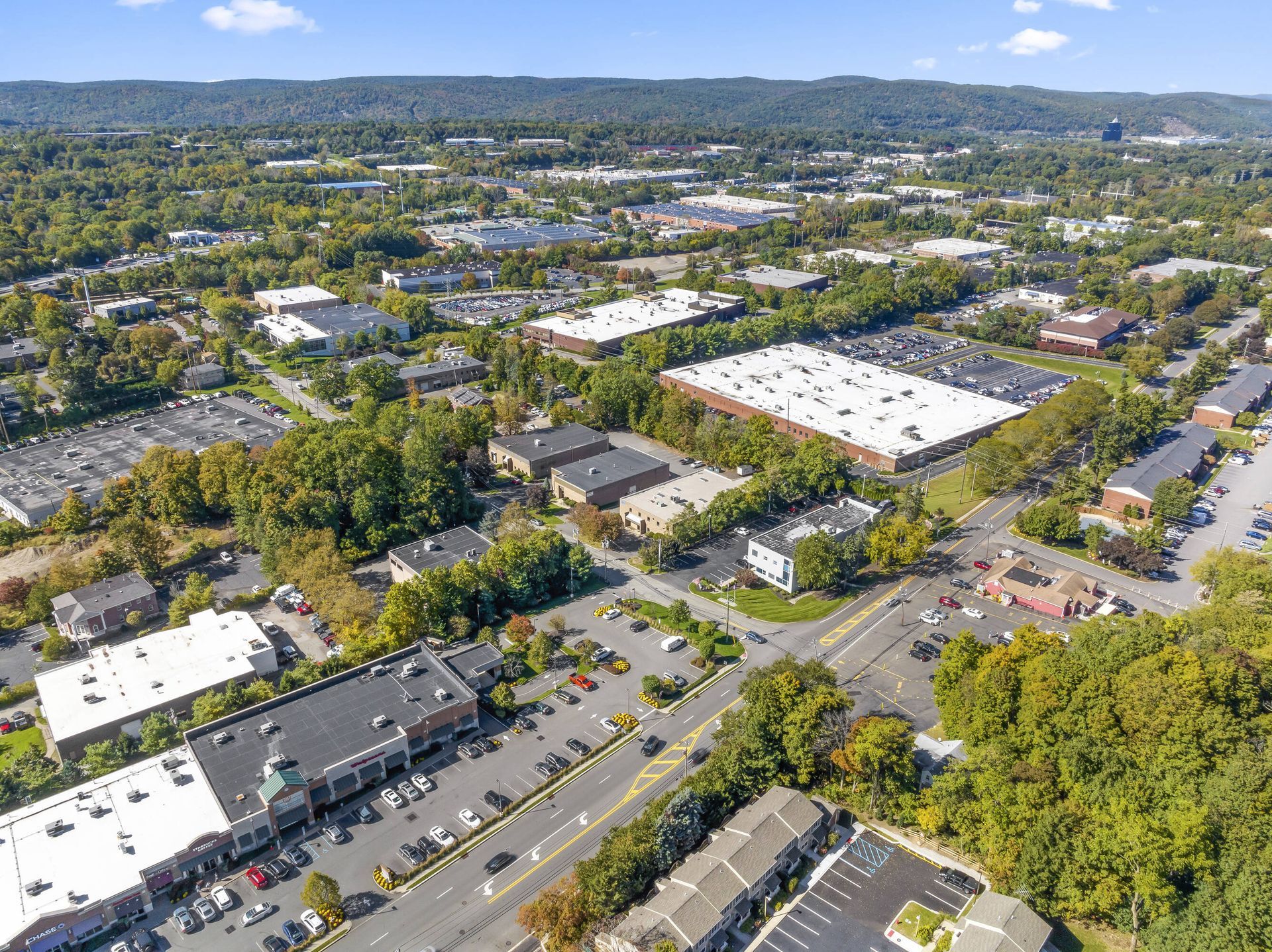An aerial view of a city with lots of buildings and trees.
