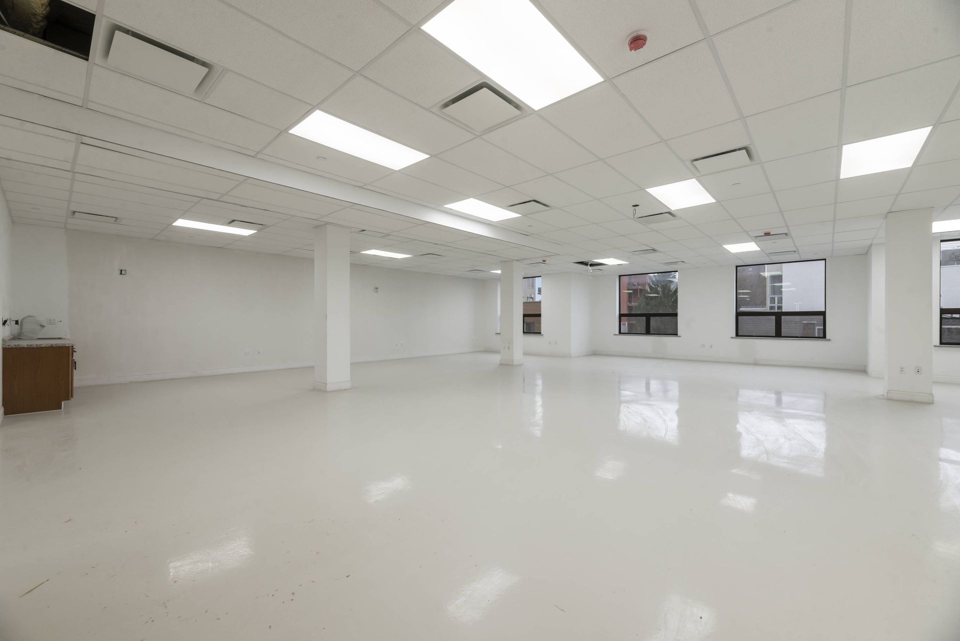 A large empty room with white walls and a white floor.