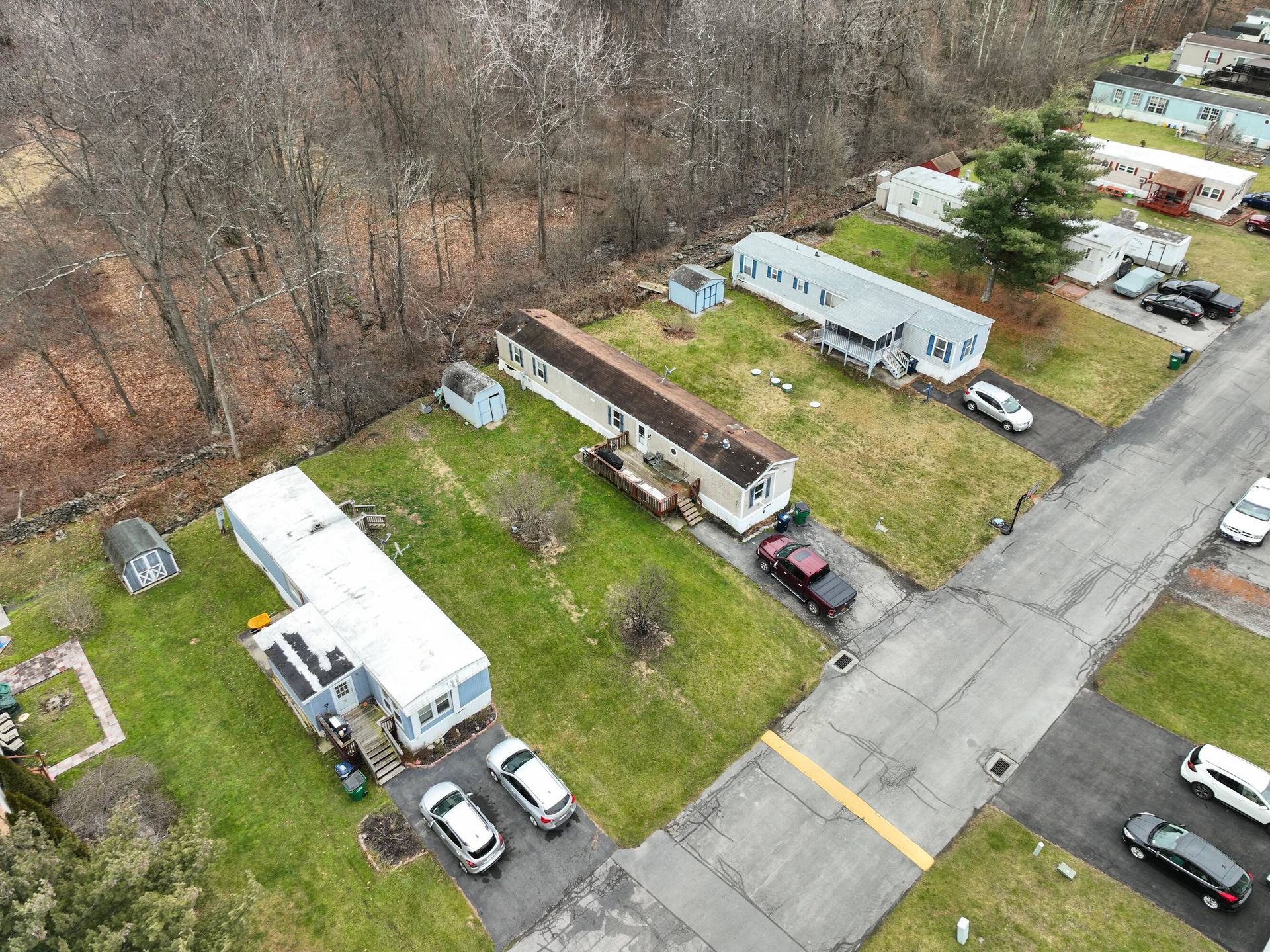 An aerial view of a mobile home park with cars parked on the side of the road.