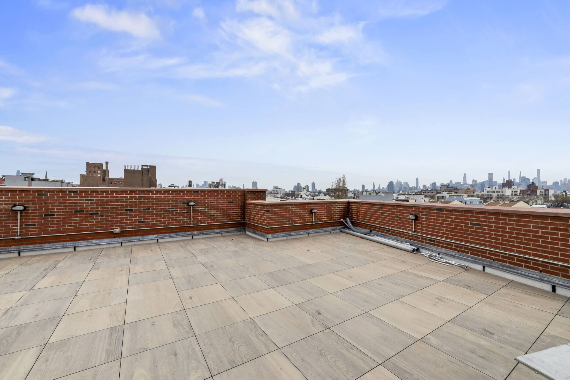 A rooftop terrace with a view of the city skyline
