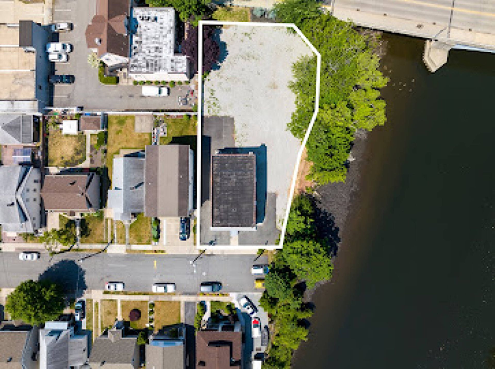 An aerial view of a residential area next to a body of water.