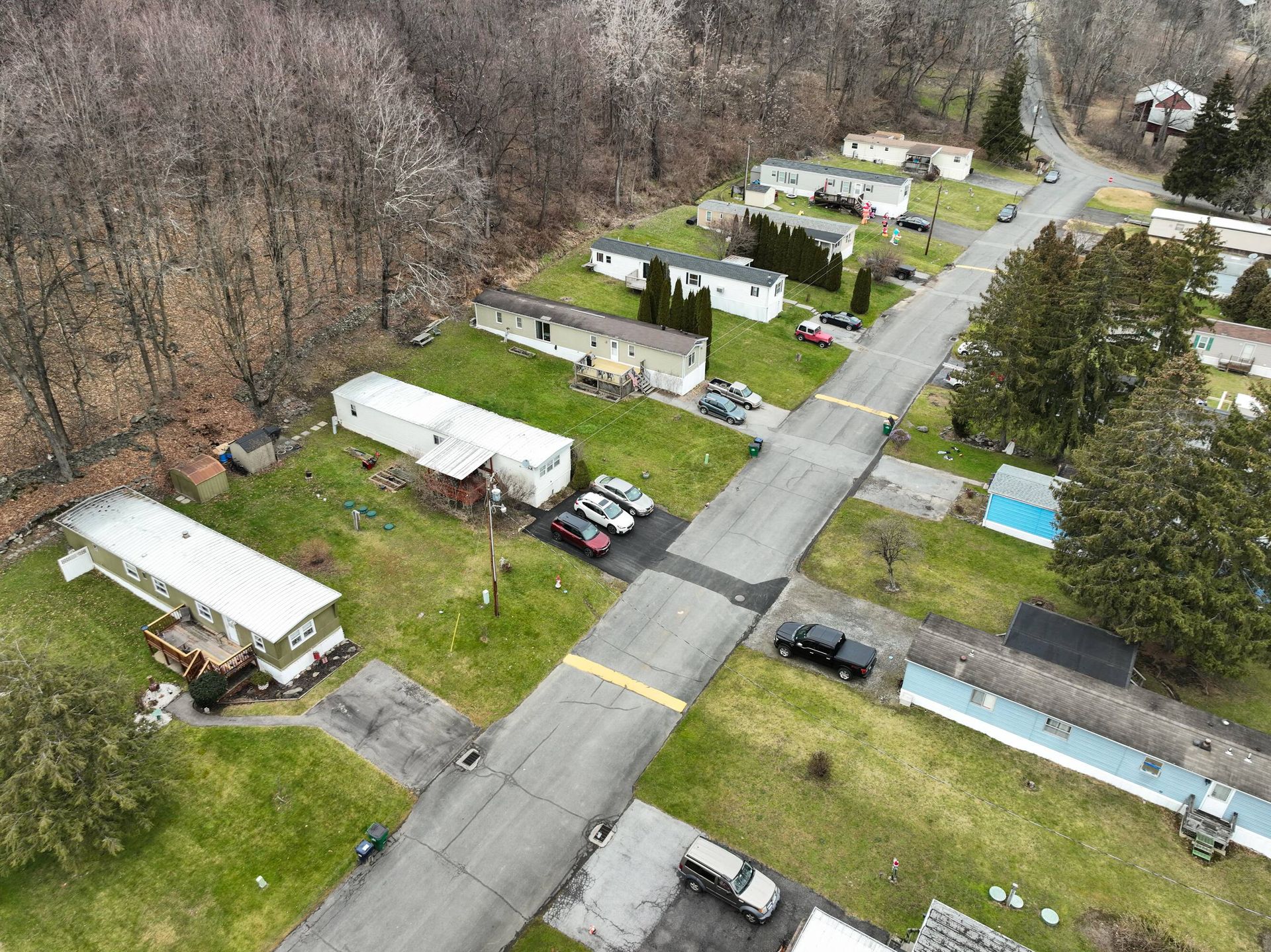 An aerial view of a mobile home park with lots of houses and trees.