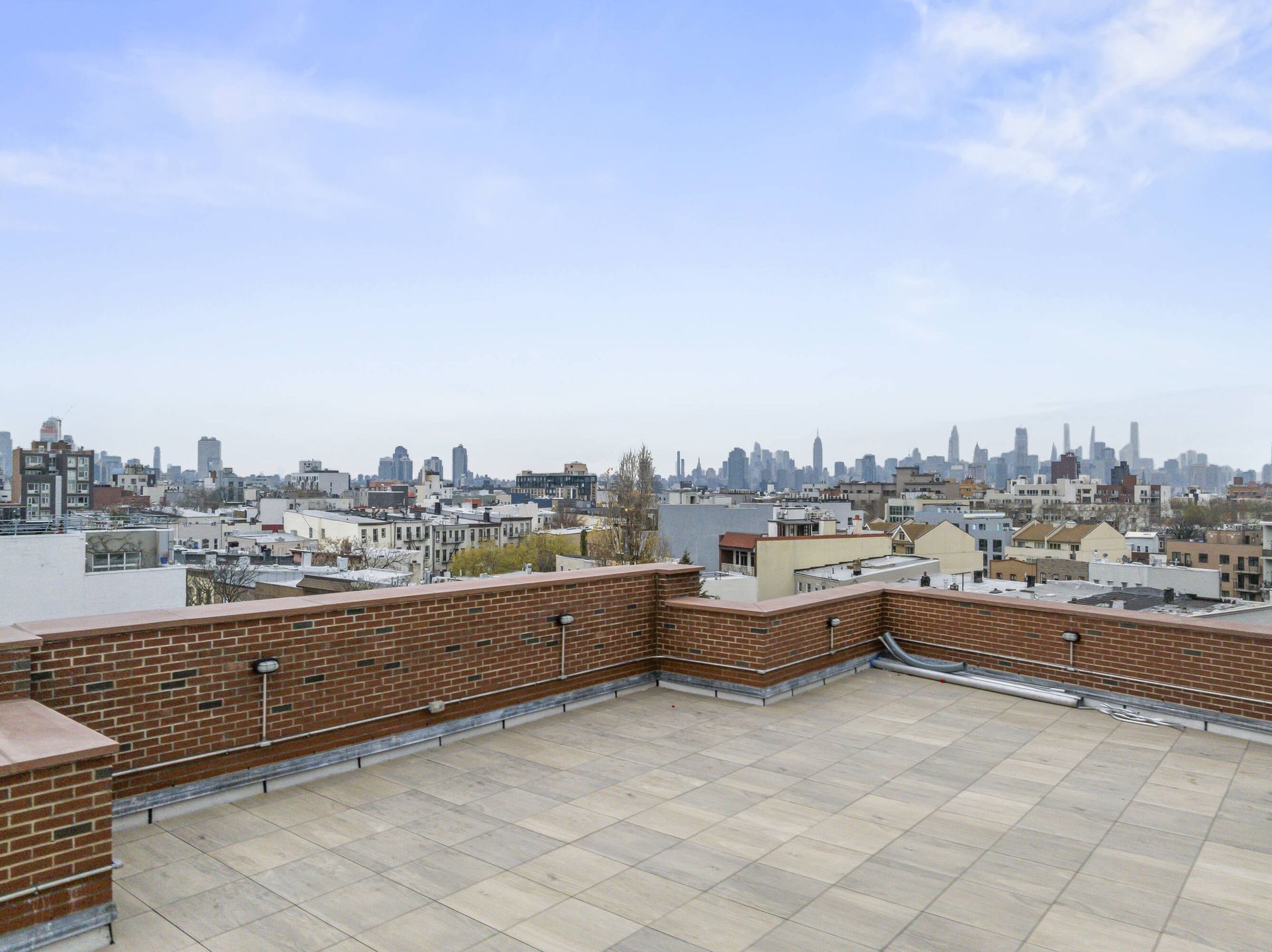 A rooftop terrace with a view of the city skyline
