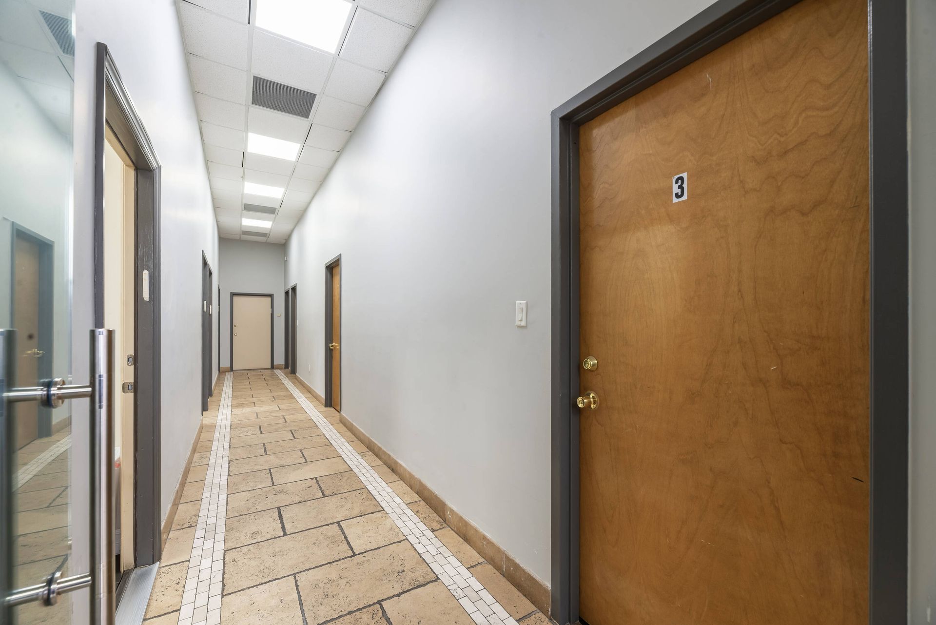 A long hallway with a number 3 on the door