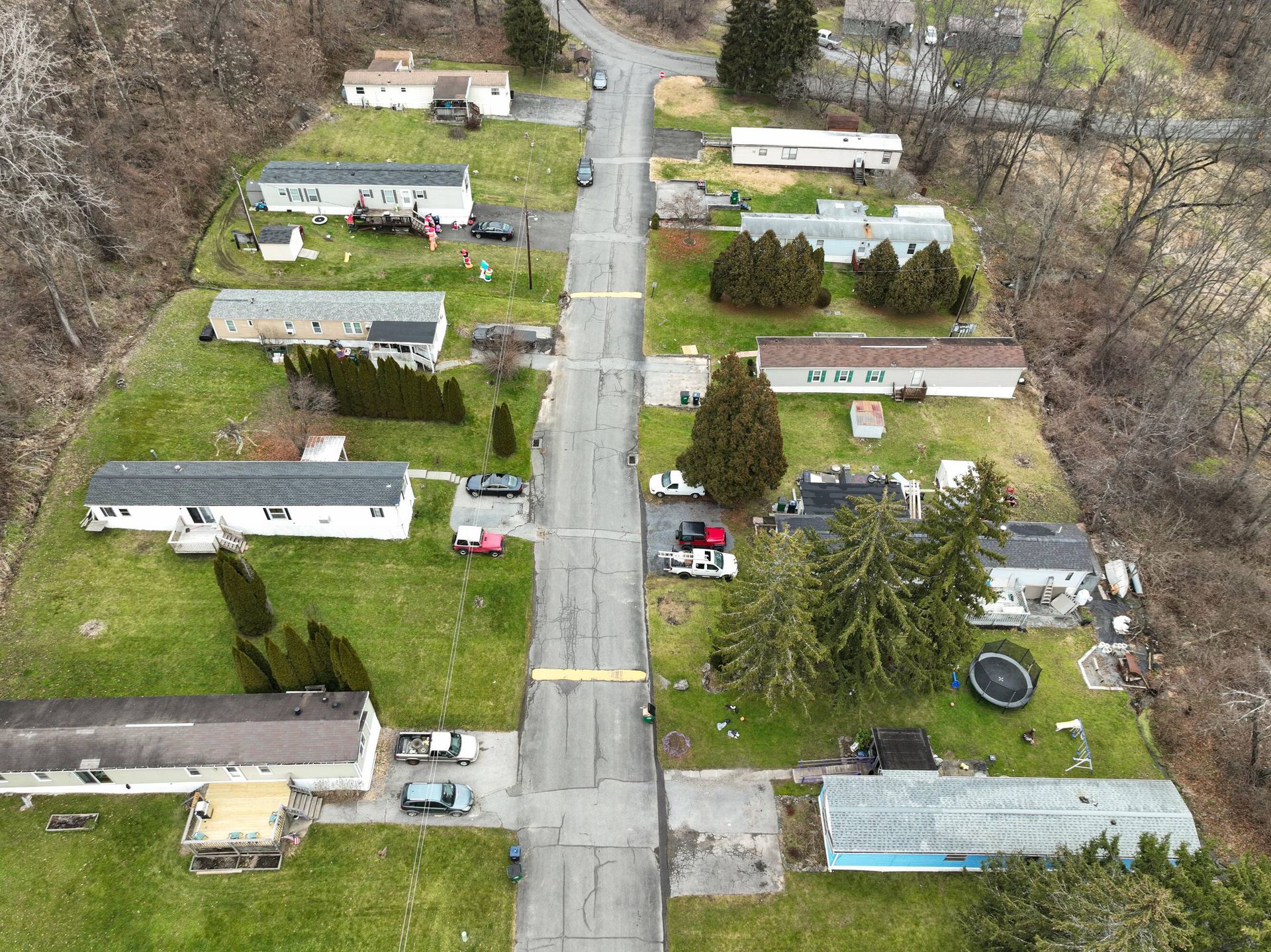 An aerial view of a mobile home park with a road going through it