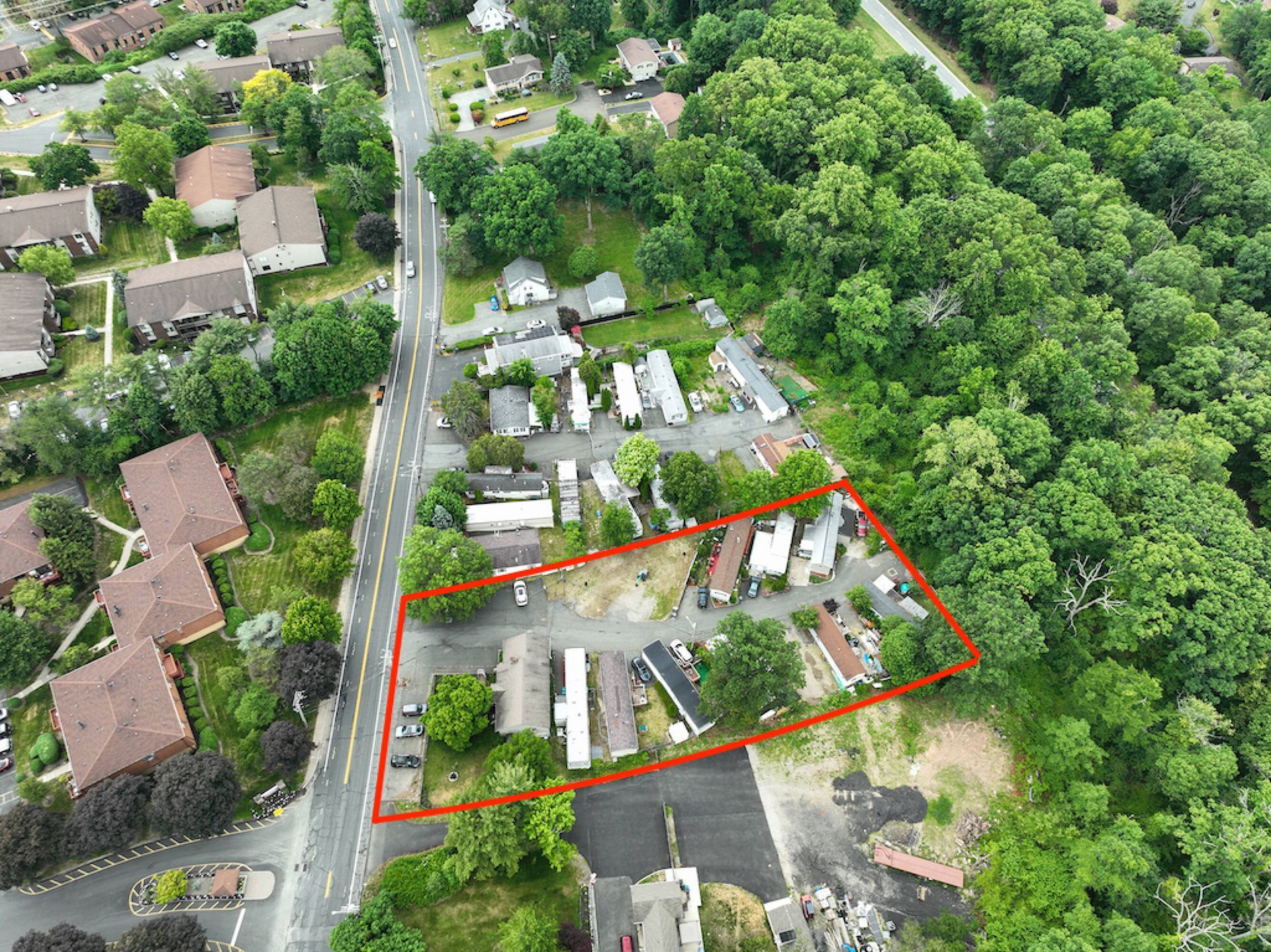 An aerial view of a residential area with a red outline around it.