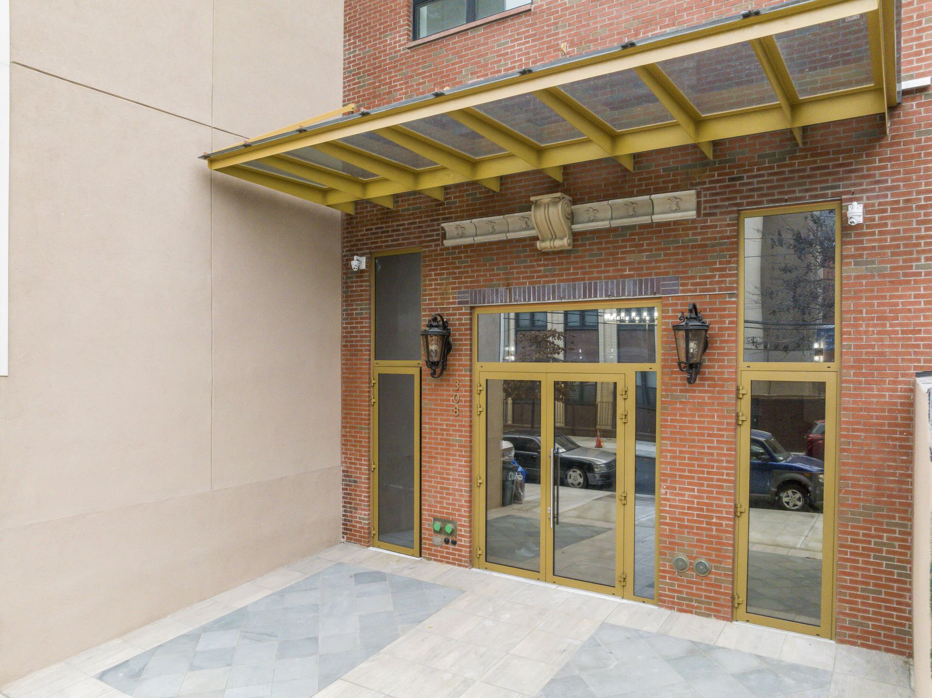A brick building with a canopy over the entrance