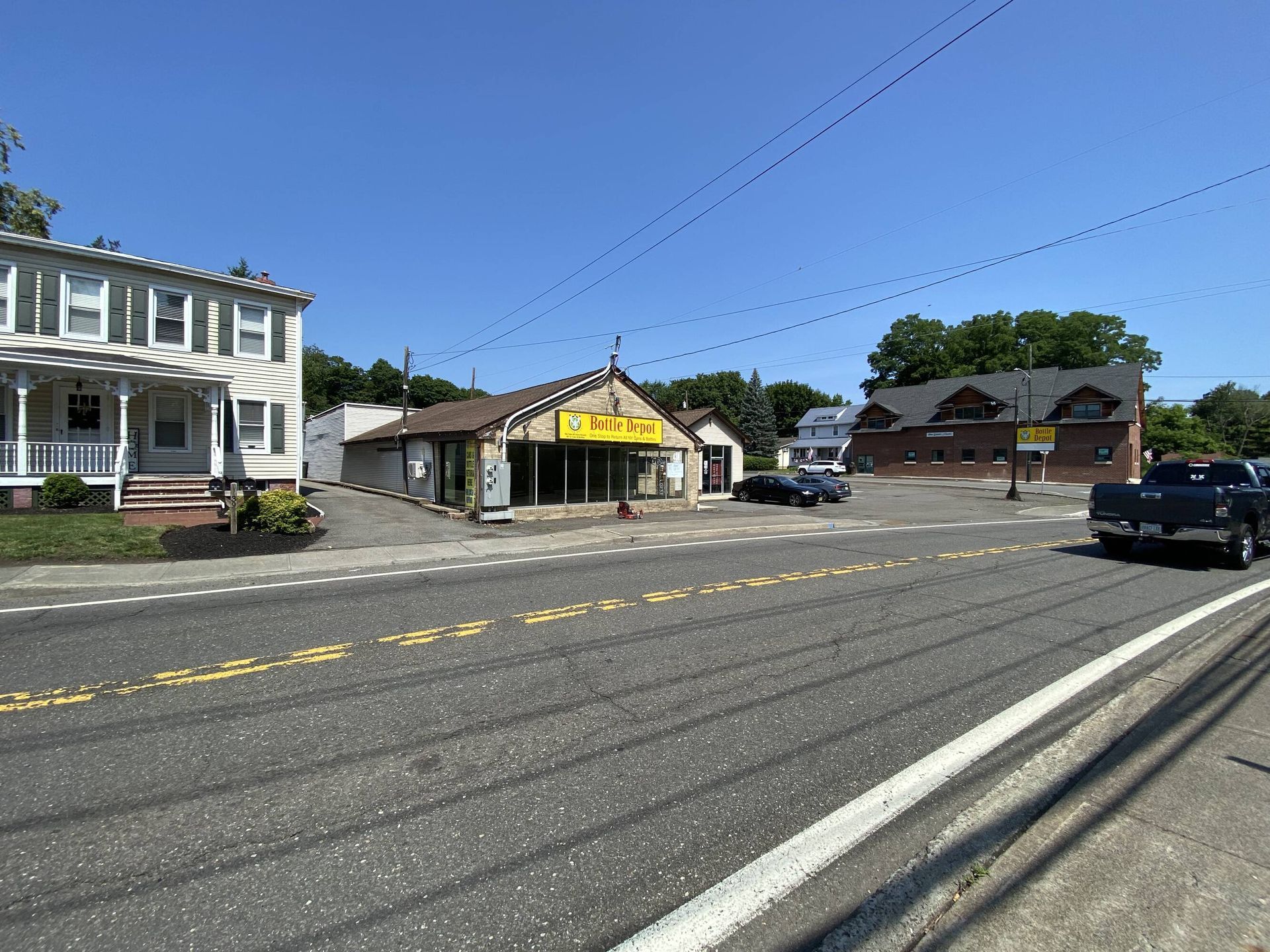 A pickup truck is parked on the side of the road