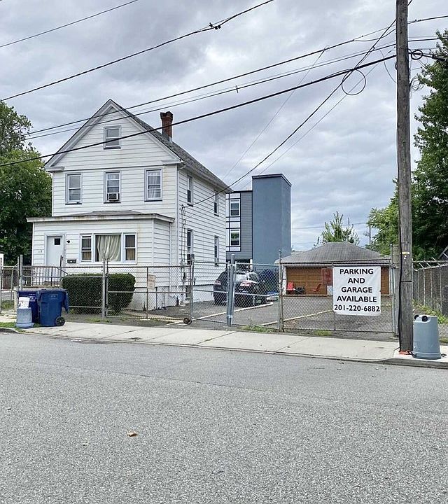 A white house with a garage in front of it