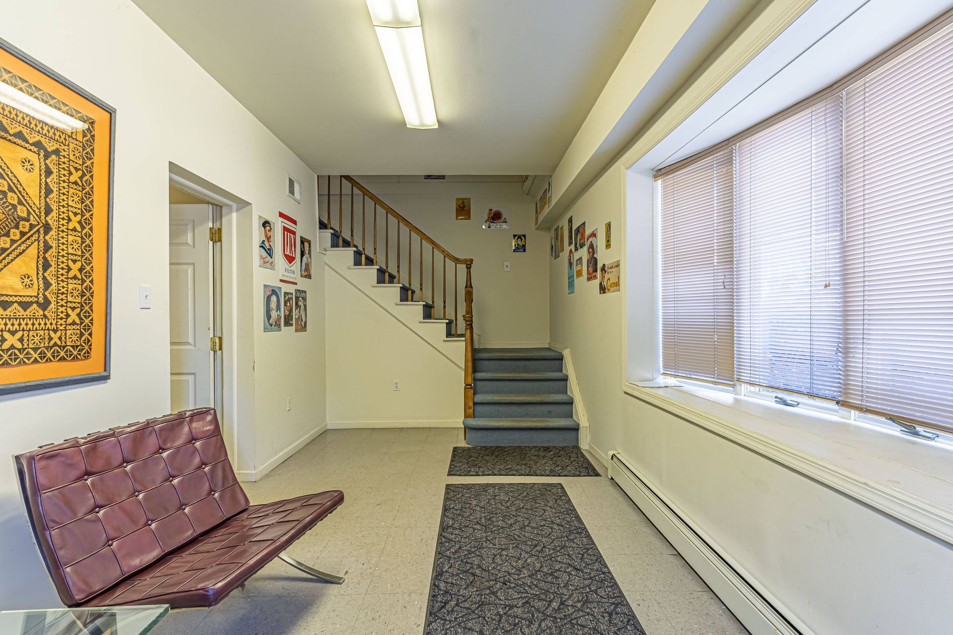 A hallway with stairs leading up to the second floor