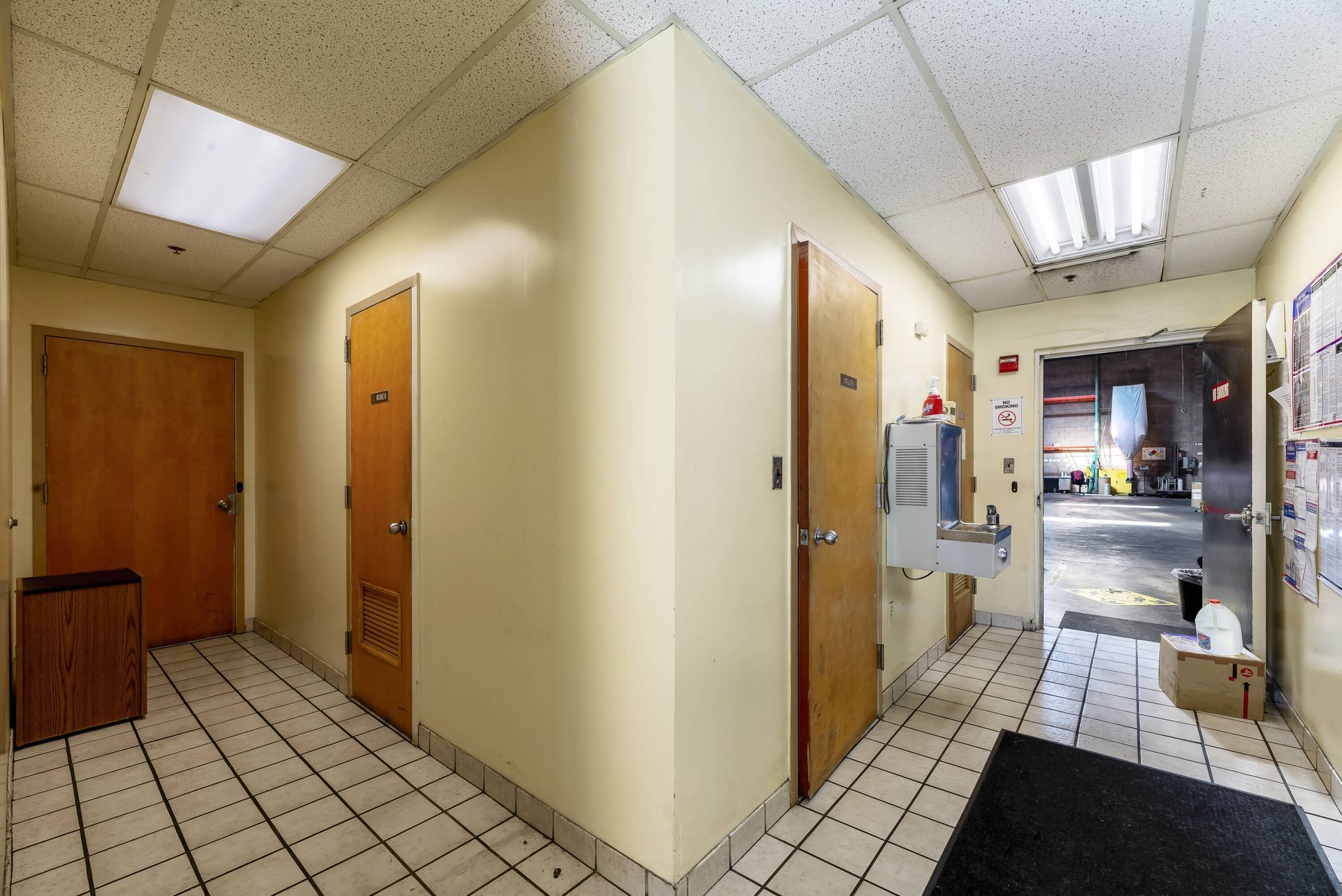 A hallway with a water fountain in the middle of it