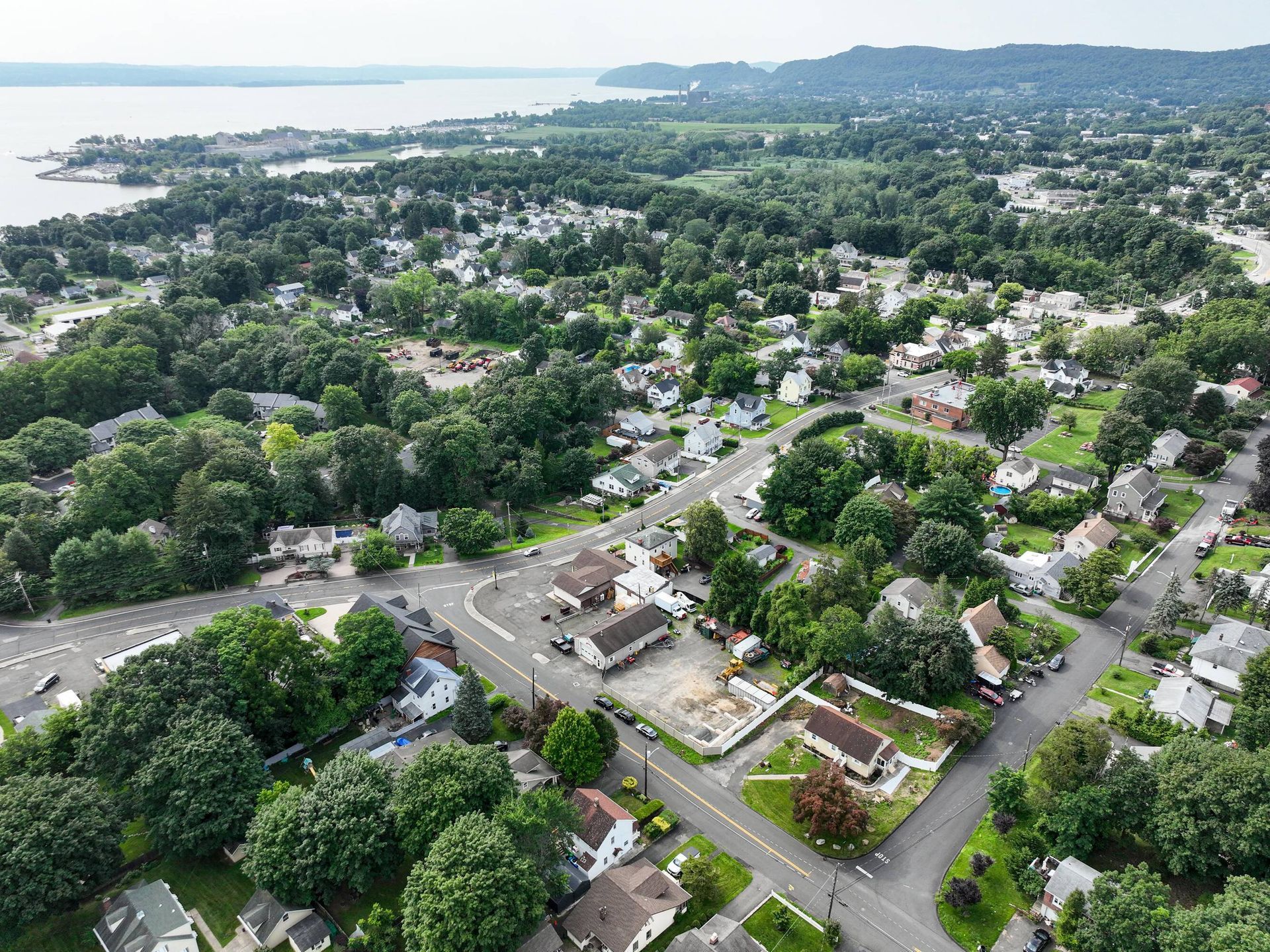 An aerial view of a residential area with a lake in the background.