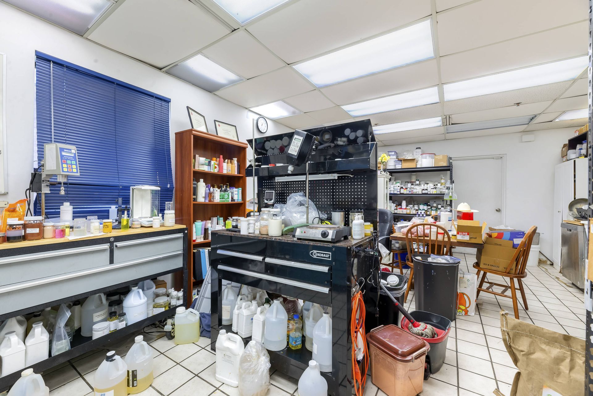 A room with a lot of bottles on the floor and shelves.