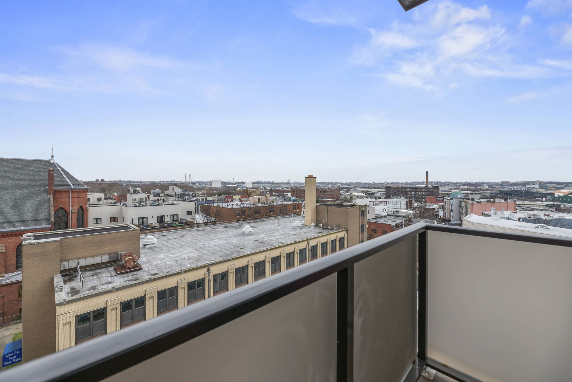 There is a balcony with a view of a city.