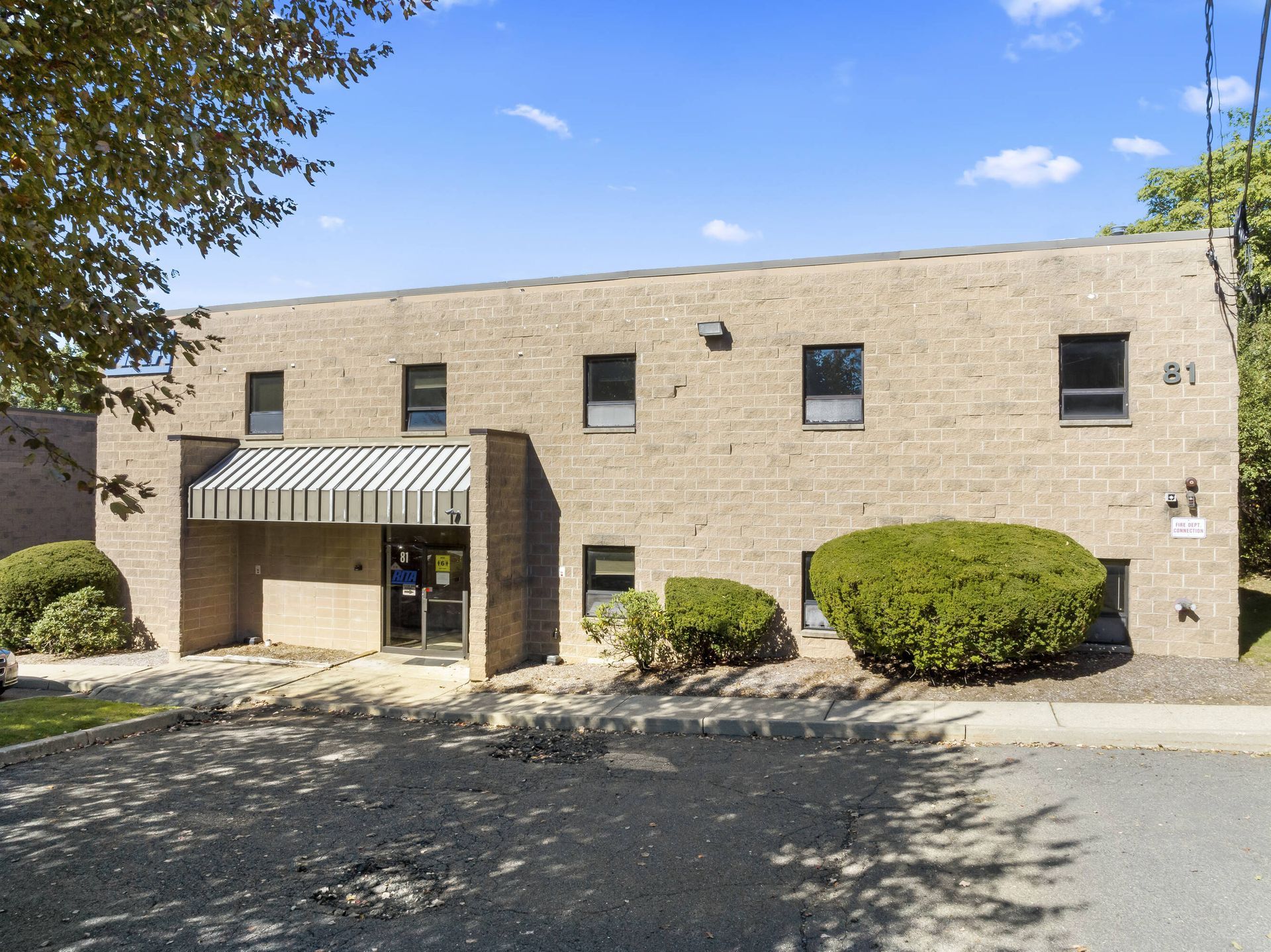 A large brick building with a canopy over the entrance