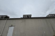 The roof of a building with a lot of air conditioners on it.