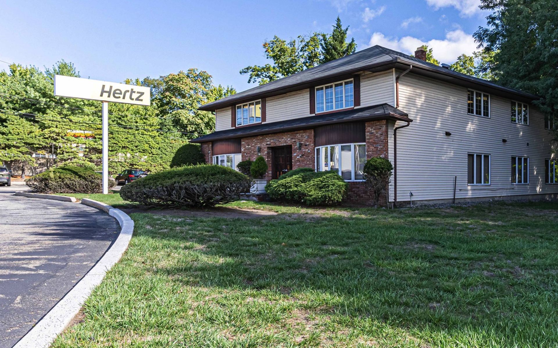 A house with a hertz sign in front of it