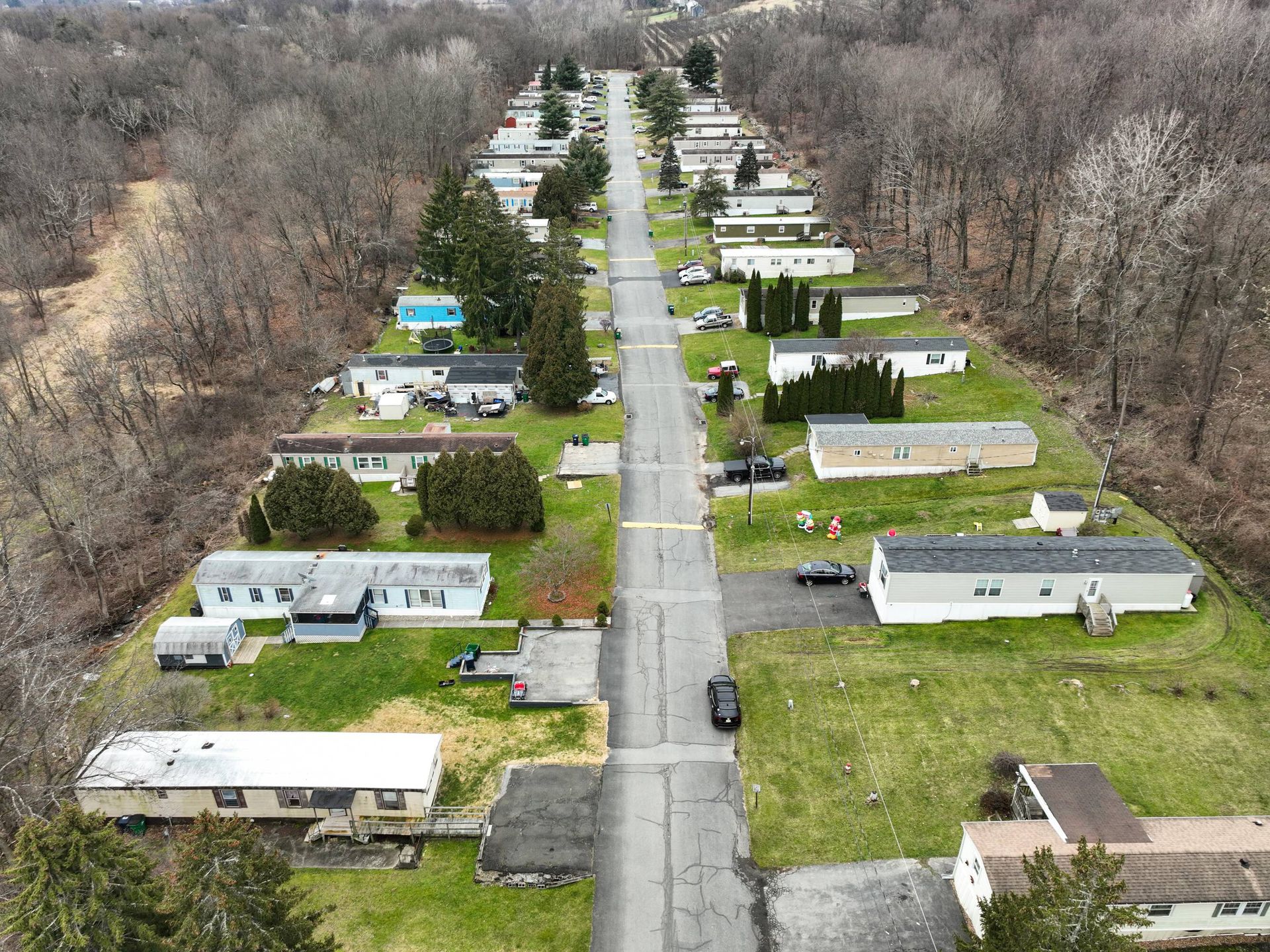 An aerial view of a mobile home park with lots of houses and trees
