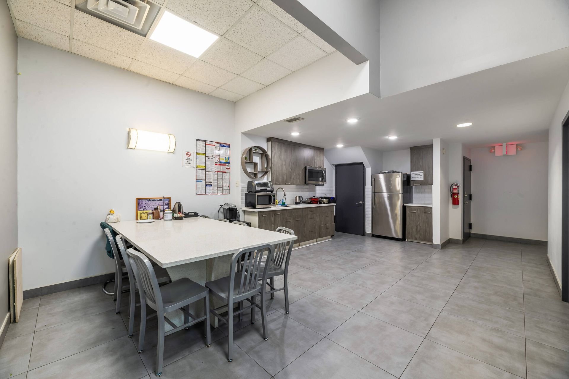 A large room with a table and chairs in it.