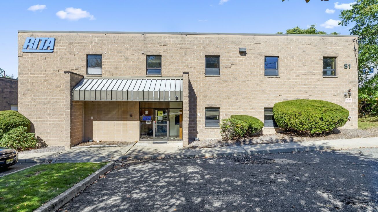 A large brick building with a canopy over the entrance.