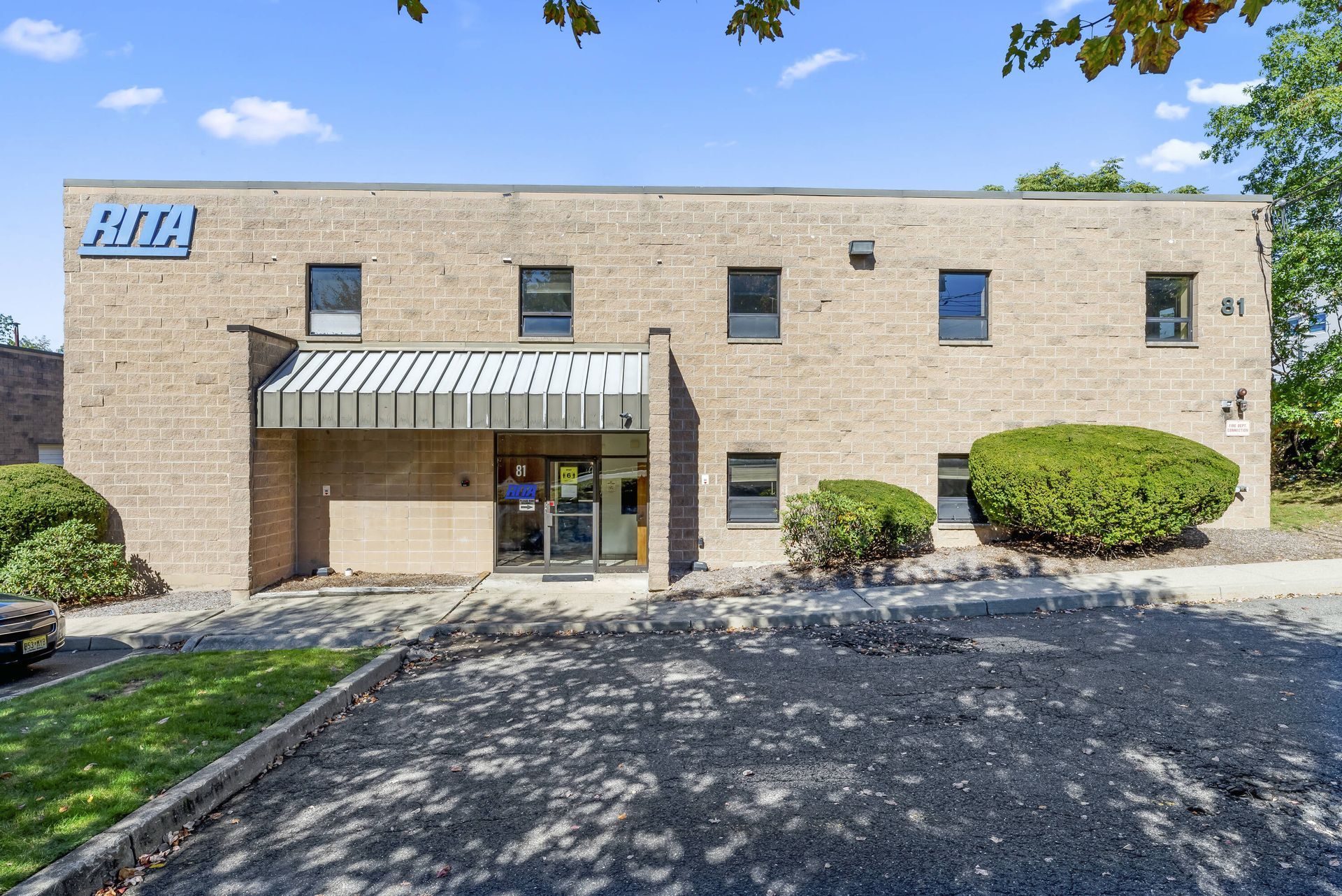 A large brick building with a blue sign on it