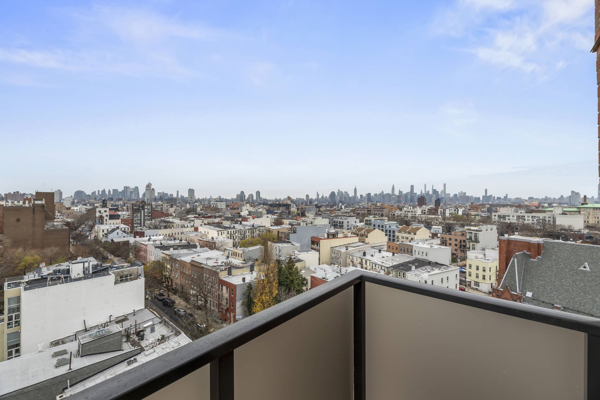 There is a balcony with a view of the city.