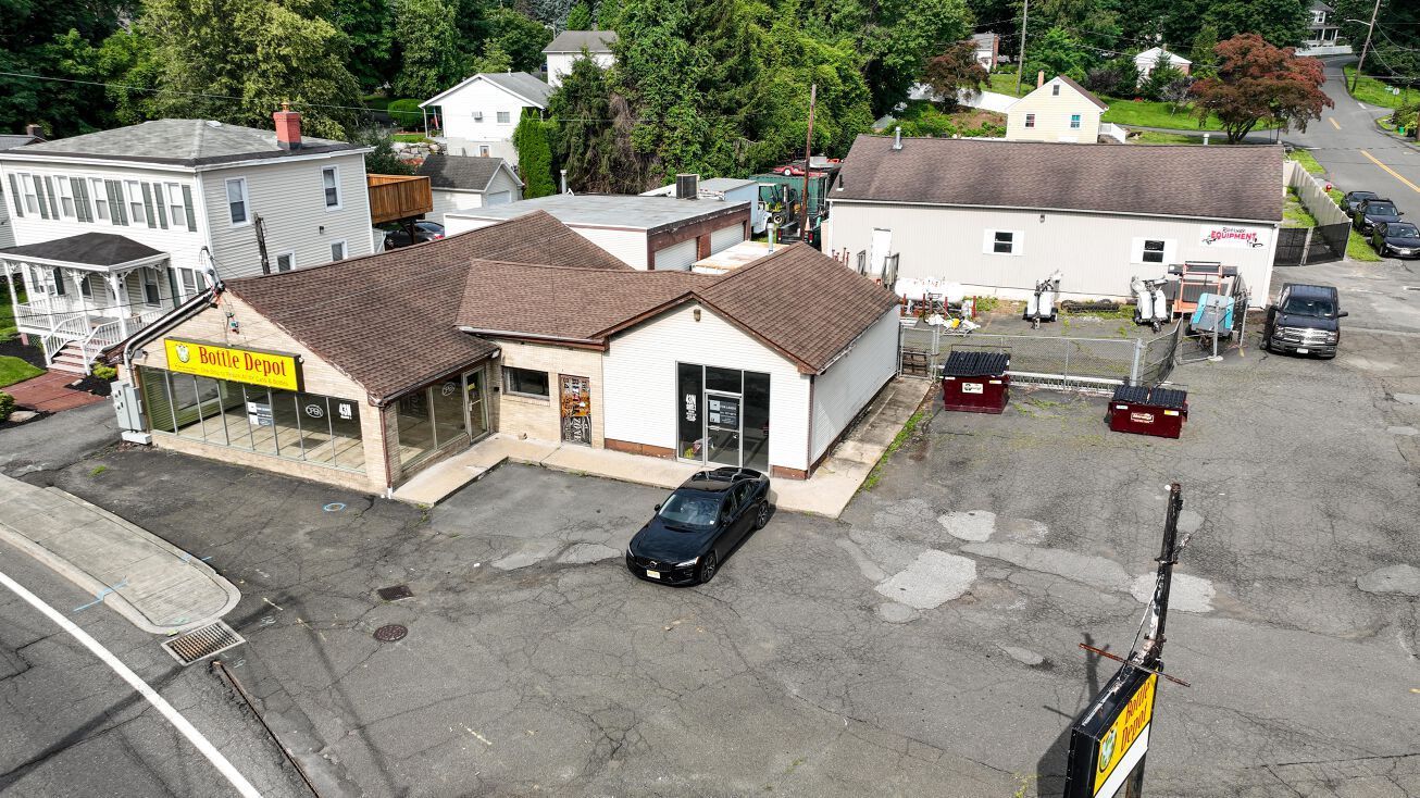 An aerial view of a small town with a car parked in front of a building.
