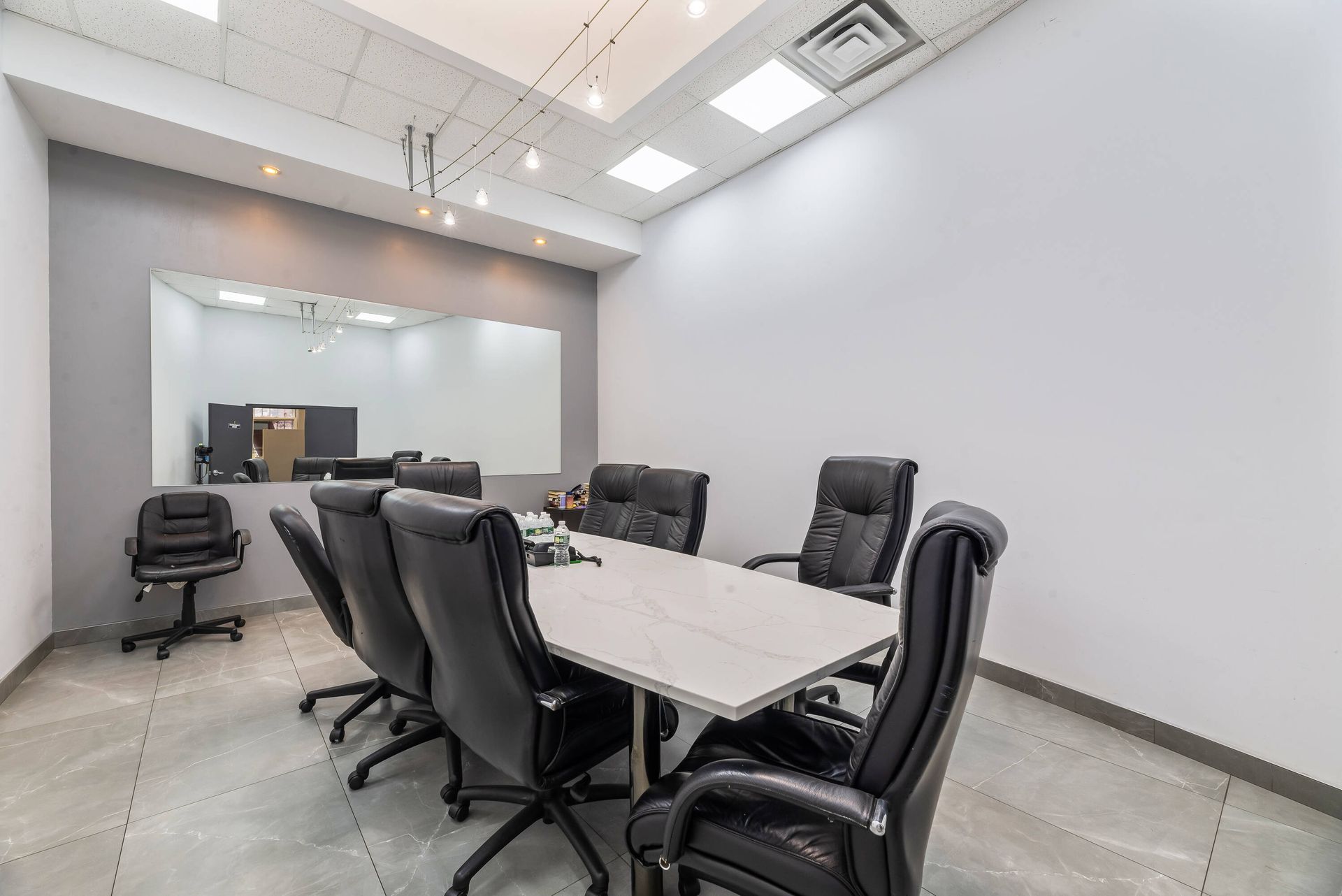 A conference room with a long table and chairs.