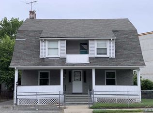 A gray house with a white porch and a gray roof.