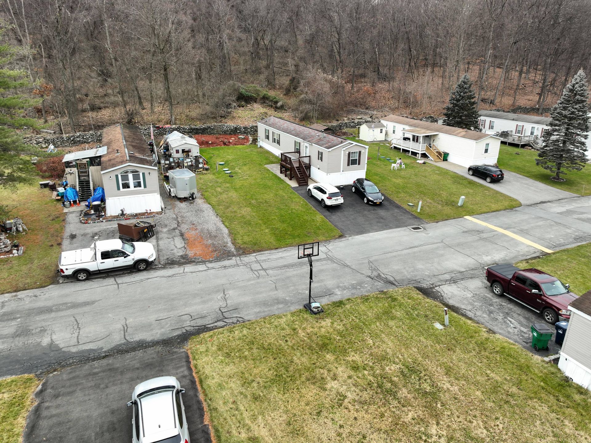 An aerial view of a mobile home park with cars parked on the side of the road.