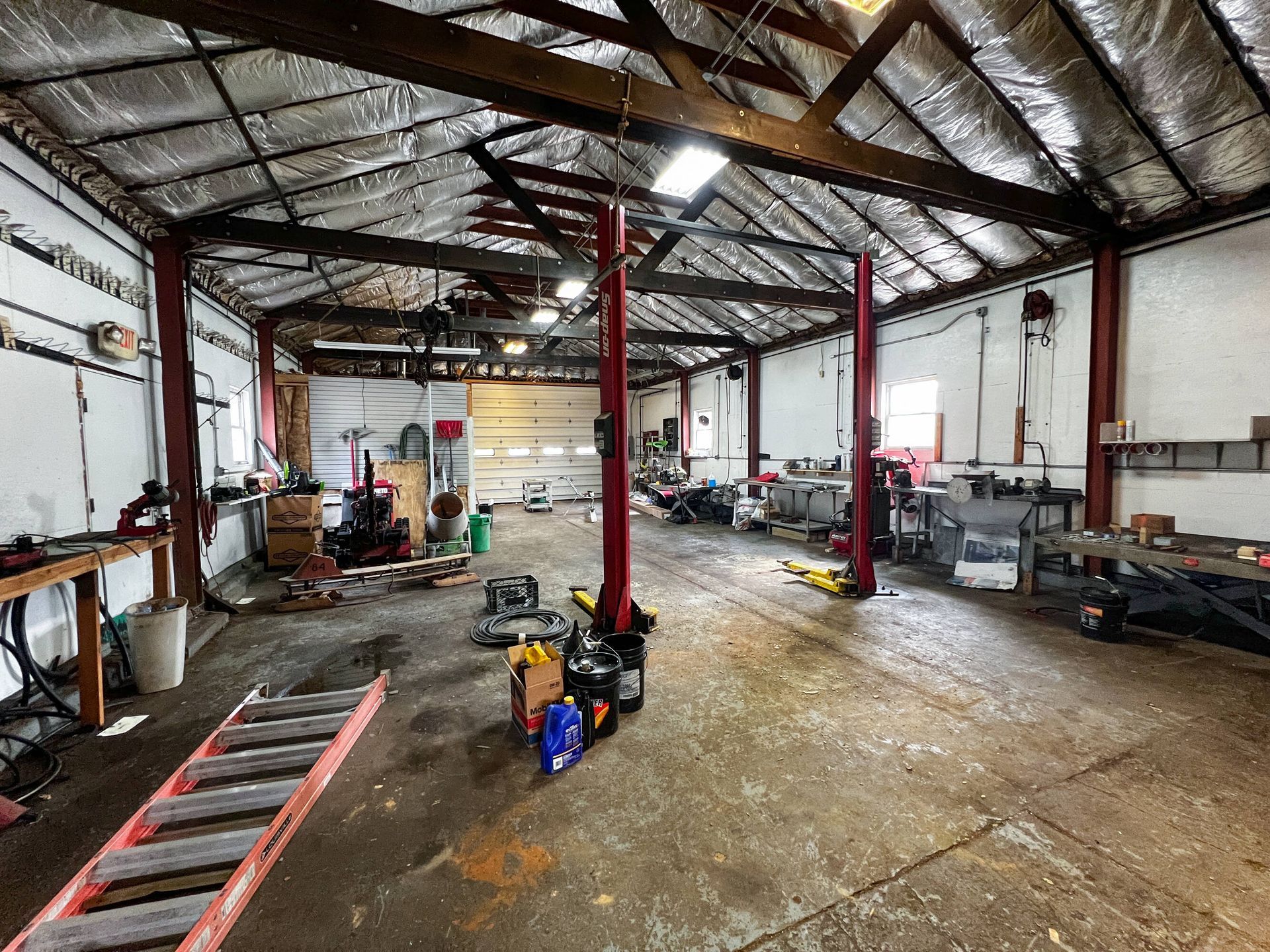 There is a ladder in the middle of the garage.