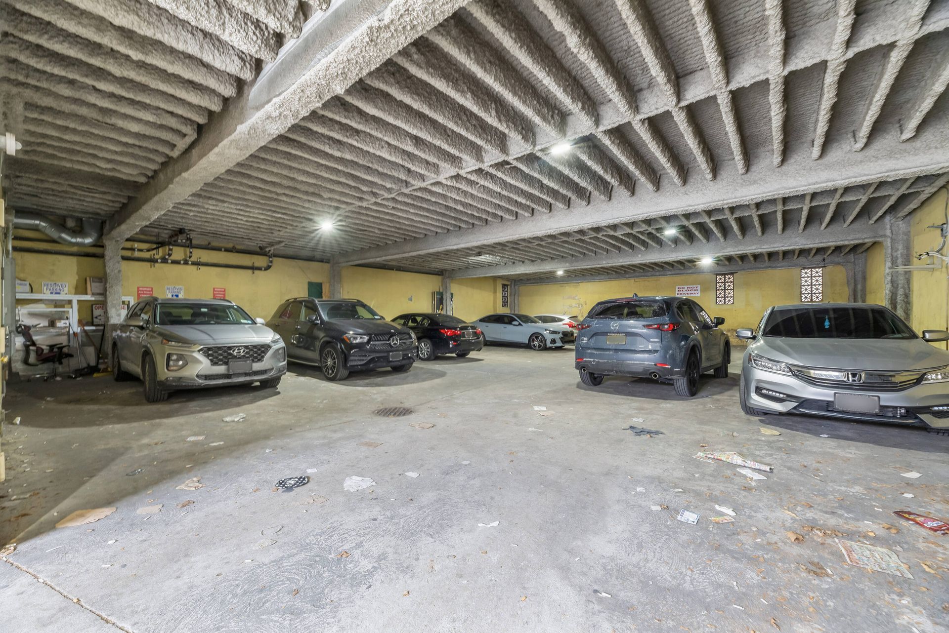 A lot of cars are parked in a parking garage.