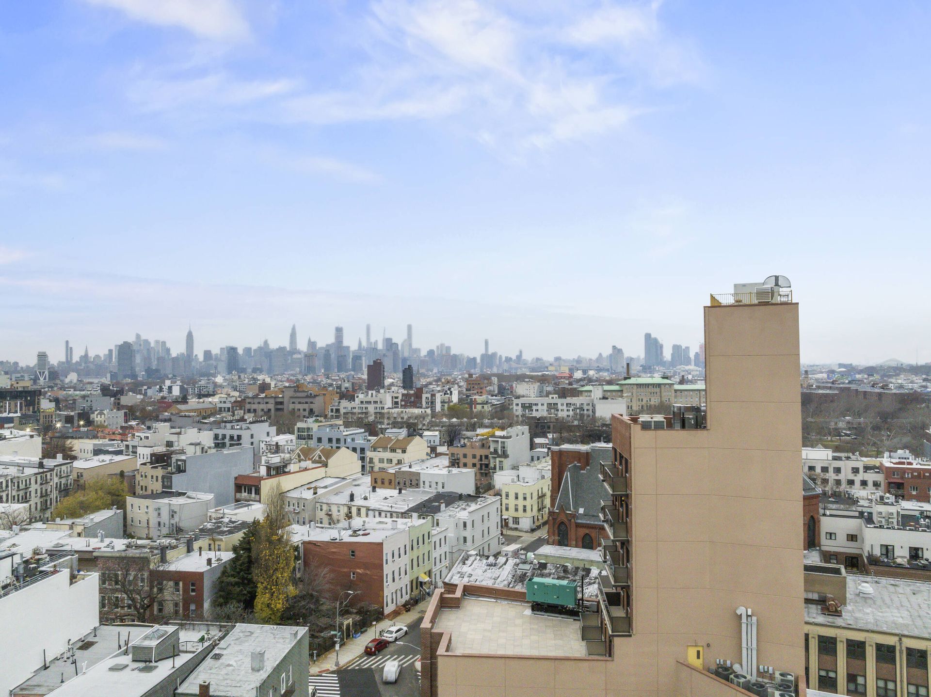 An aerial view of a city with a building in the foreground
