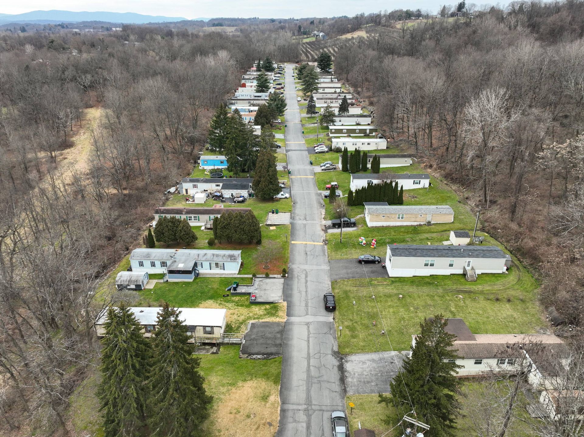 An aerial view of a mobile home park with houses and trees