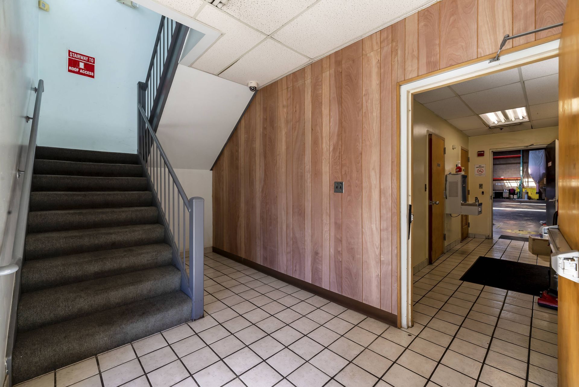A hallway with stairs leading up to the second floor of a building