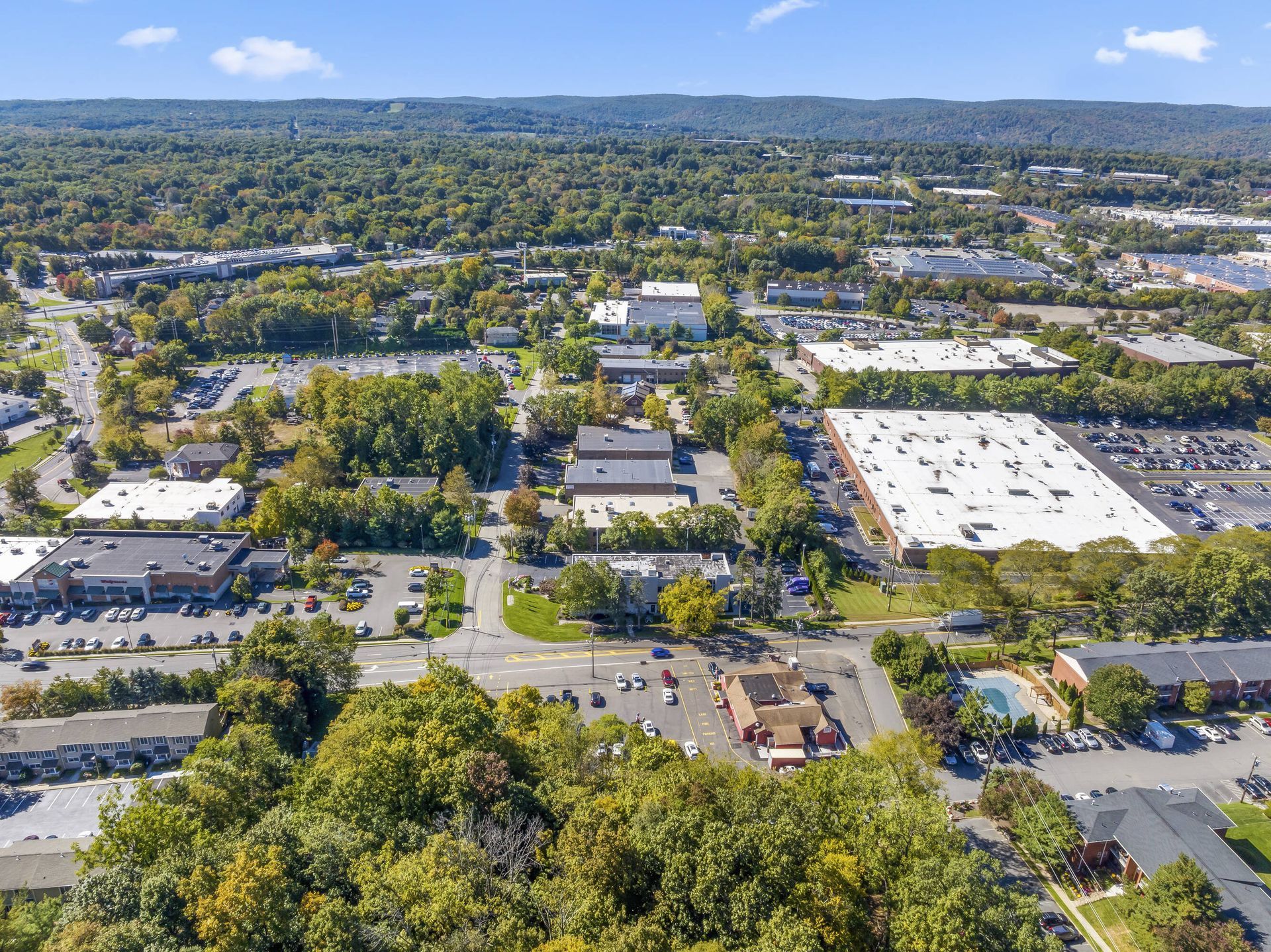 An aerial view of a city with lots of buildings and trees.